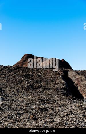 Unique panoramic view of spectacular lava river flows fromhuge volcano crater, creates martian landscape on planet earth. Mountains of fire, Timanfaya Stock Photo