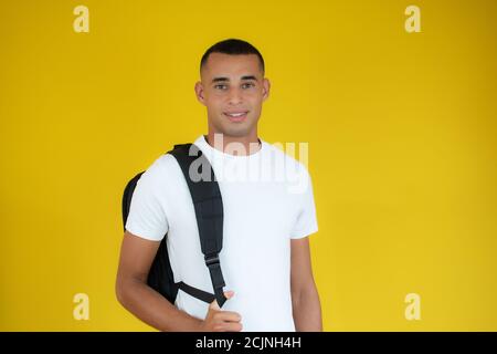 Young handsome man wearing student backpack smiling happy and positive Stock Photo