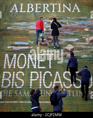 People walk up stairs painted in perspective to advertise an exhibition at Albertina museum in Vienna, Austria, November 6, 2015. The exhibition 'Monet to Picasso' runs in the museum until March 10, 2017. REUTERS/Heinz-Peter Bader