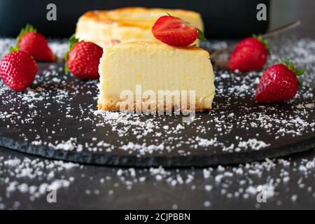 small cheesecake with strawberries on dark background Stock Photo