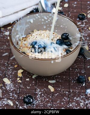oatmeal milk splash on dark background Stock Photo