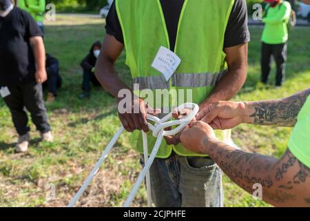 Detroit, Michigan - Workers from the Detroit Grounds Crew learn how to use the ropes they will need in taking down dead or unwanted trees. Stock Photo