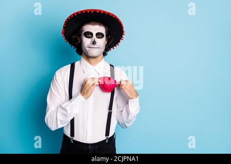 Portrait of his he handsome scary content cheery imposing guy gentleman wearing sombrero adjusting festal accessory Santa Muerte cult ritual isolated Stock Photo