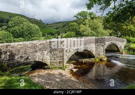 Buckden Bridge over the River Wharfe at Buckden in Upper Wharfedale in the Yorkshire Dales National Park in September. Stock Photo