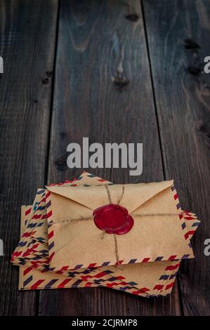 Old letters envelopes with a wax stamp on wooden table Stock Photo