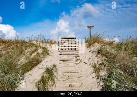 Wooden old stairs built on sand hills built by strong winds, with ravines and erosion on the Baltic Sea Stock Photo