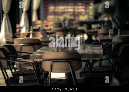 Restaurant table set up for diners. Romantic late evening fine dining date dinner. Stock Photo