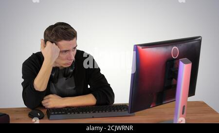 Upset gamer expressing disappointment watching online game on gr Stock Photo