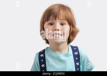 healthy children's teeth. gorgeous positive boy in trendy blue shirt and suspenders Stock Photo