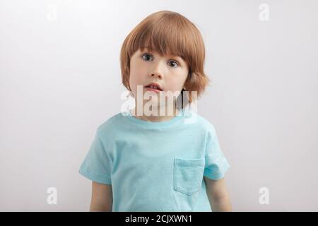 upset, unhappy, serious boy in stylish t-shirt looking at the camera Stock Photo