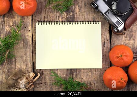 Cozy Christmas composition. Tangerines, coniferous branches, wooden skates. Stock Photo