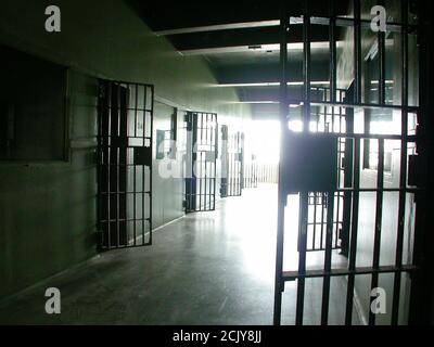 View inside closed jail cell block in an unused rundown government owned facility. Stock Photo