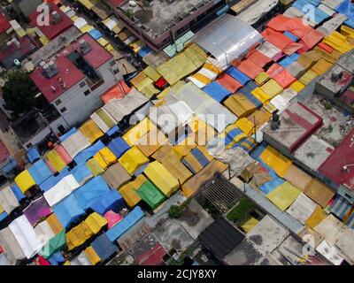 Archival 2002 aerial view of colorful tarps filling the streets at the popular Tepito Market in urban Mexico City. Stock Photo
