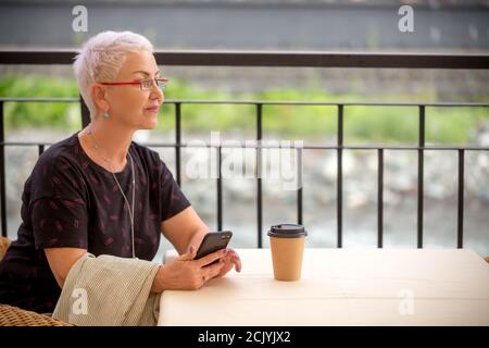 a pensive tourist woman is resing in the coffee shop. close up side view photo Stock Photo