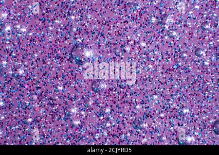 Macro of transparent glowing slime with glittering particles and bubbles inside Stock Photo