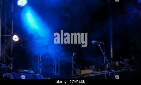 Free stage with blue lights before concert, lighting devices, microphone Stock Photo