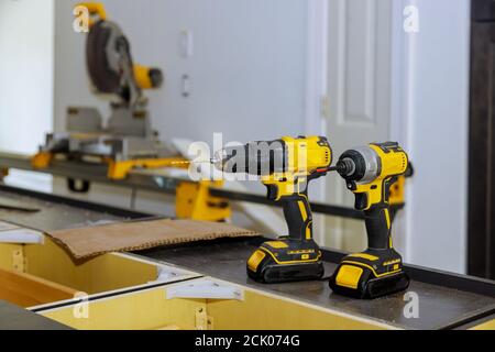 Two cordless drills with drill bits working also as screwdriver guns on drill instrument professional tool as woodworker Stock Photo