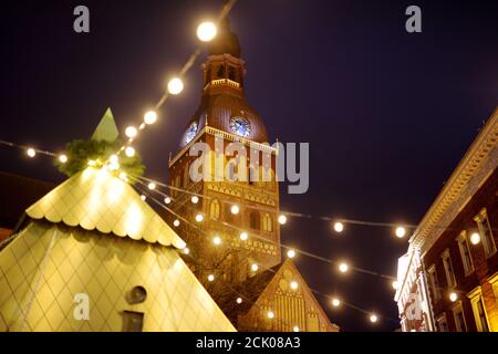 The most authentic Christmas market in Riga offering dozens of crafts and food stalls, as well as giant Christmas tree. Night time. Stock Photo