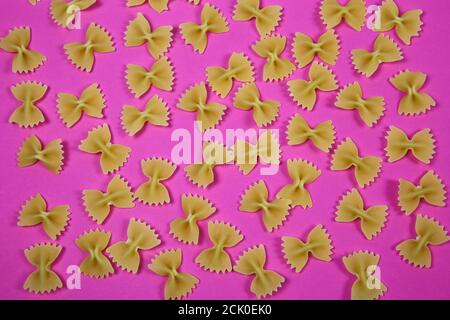 High angle view on isolated many farfalle noodles on pink background Stock Photo