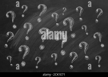 Question marks on blackboard Ask for help. FAQ concept.  Asking questions. Stock Photo