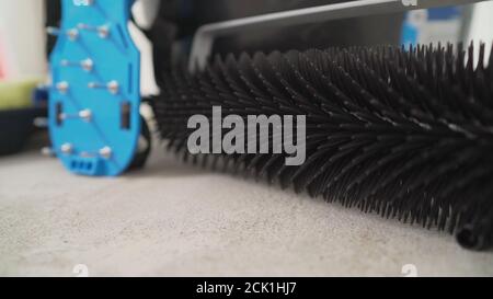 Walking shoes with needle roller and wet screed. Needle roller for self-leveling floor. concrete floor. on the horizon. close-up. needle roller to Stock Photo