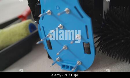 Walking shoes with needle roller and wet screed. Needle roller for self-leveling floor. concrete floor. on the horizon. close-up. needle roller to Stock Photo