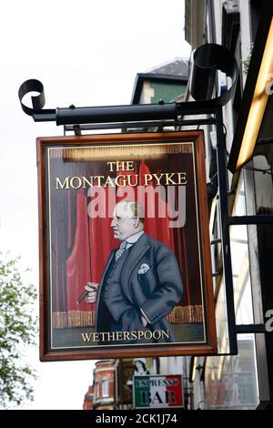 London, UK - May 06, 2012: English pub sign, Public house, known as pub, is focal point of community. Pub business, now about 53,500 pubs in UK, has b Stock Photo