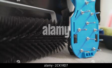 Walking shoes with needle roller and wet screed. Needle roller for self-leveling floor. concrete floor. on the horizon. close-up. needle roller to Stock Photo