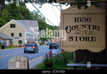 The general view of Vermont Route 9 in town of Wilmington with the traditional wooden sign of 1836 country Store in foreground.Wilmington.Vermont.USA Stock Photo
