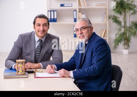 Two businessmen in the time management concept Stock Photo