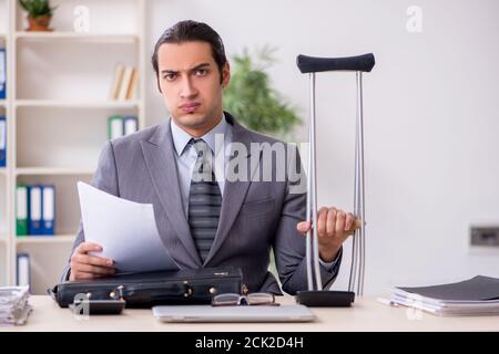 Young employee after accident at workplace Stock Photo