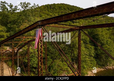 Aerial view of torn damaged Stars and Stripes flag on the historic metal truss Jenkinsburg Bridge near Morgantown Stock Photo