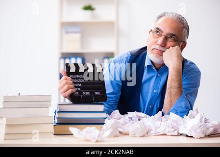 Old male author writing the screenplay Stock Photo