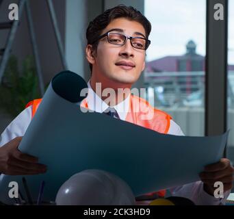 The construction architect working on drawings late at night Stock Photo