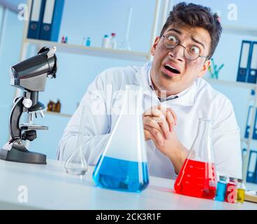 Funny mad chemist working in a laboratory Stock Photo