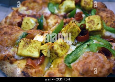 Closeup shot of a pizza with assorted toppings Stock Photo