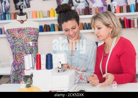 two yung dressmakers choosing color samples in their workshop Stock Photo
