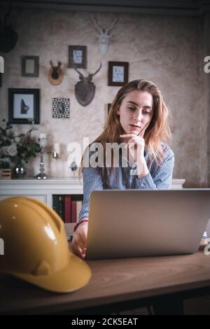 Architect Design is Working in Home Workplace While Thinking Creative  Architecture Drawing on Laptop, Home Creativity Interior Designer is Using Comp Stock Photo