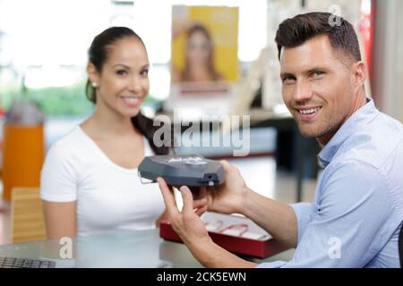 optician checks the eyes of a client Stock Photo