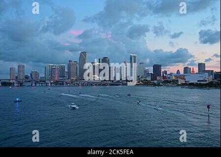 Miami, Florida - July 4, 2019 - Boats gather in front of City of Miami skyline at dusk ahead of Independence Day fireworks display. Stock Photo