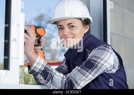 female builder using cordless drill Stock Photo