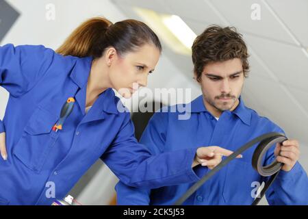 woman checking a car timing belt Stock Photo