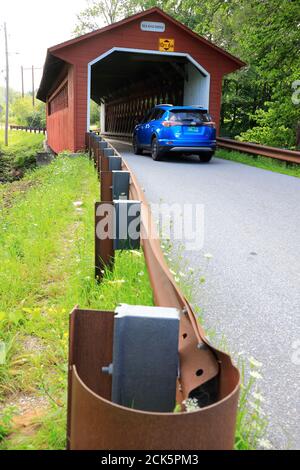 A vehicle driving into Silk Road Covered Bridge over Walloomsac River.Bennington.Vermont.USA Stock Photo