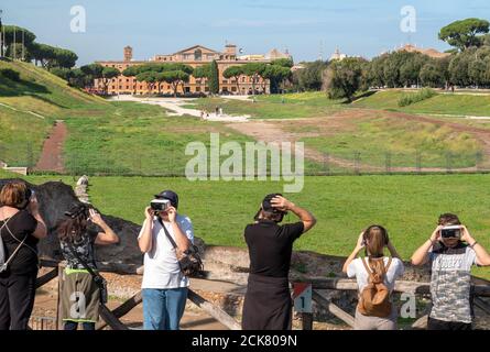 Rome Circus Maximus group of tourists wearing VR augmented reality headsets viewing the virtual 3d reconstruction of the ruins of Ancient Rome Stock Photo