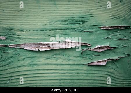 Painted board with peeling paint. Aging process and the effects of weather conditions. Abstract background Stock Photo