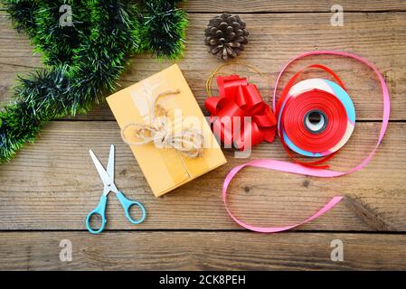 diy gift concept / Homemade wrapped christmas presents with tools and decorations on wooden , DIY hobby gift box wrapped brown paper collection in for Stock Photo