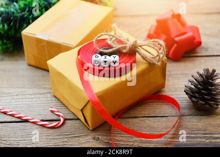 diy gift concept / Homemade wrapped christmas presents with tools and decorations on wooden , DIY hobby gift box wrapped brown paper collection in for Stock Photo
