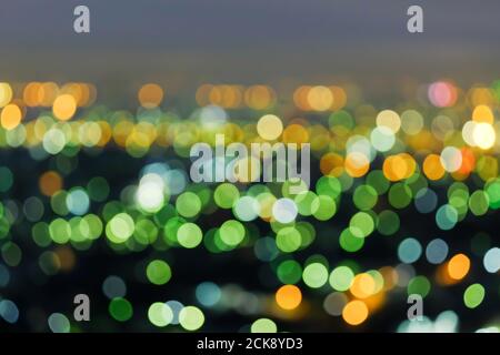 Defocus cityscape at twilight, bright and colourful blurred background with bokeh circle round lights, abstract bokeh for creative background. Stock Photo