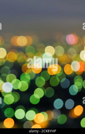 Defocus cityscape at twilight, bright and colourful blurred background with bokeh circle round lights, abstract bokeh for creative background. Stock Photo