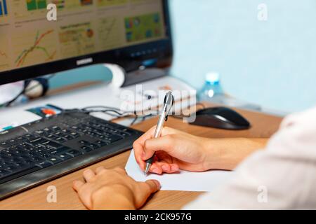 Young man preparing to take lecture notes, working at the computer, e-learning concept. Stock Photo